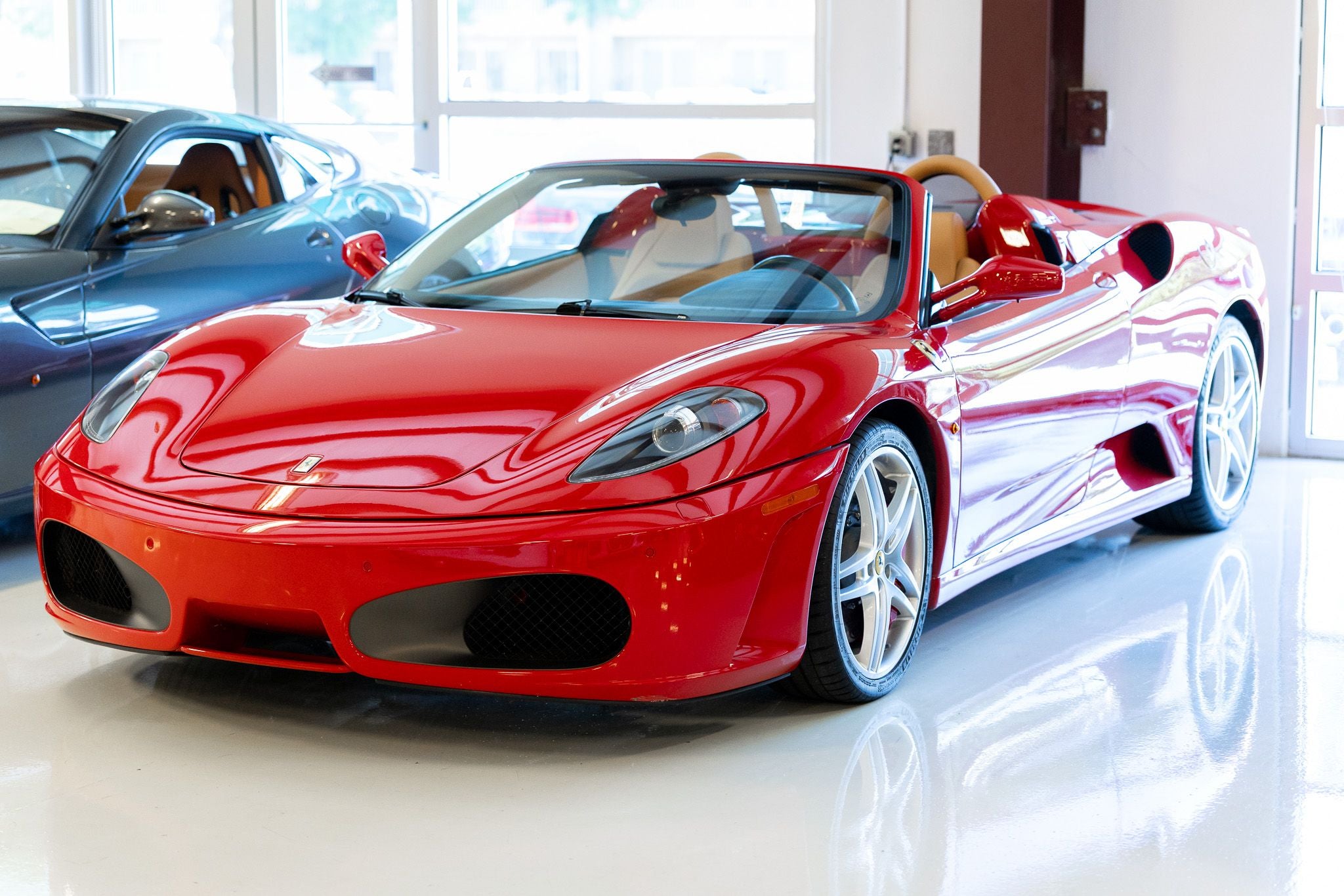 Red 2008 Ferrari F430 Spider with the top down in the Rosner Motorsports showroom