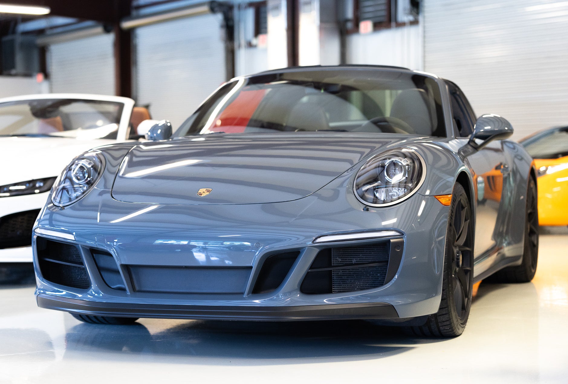 Graphite Blue 2018 Porsche 911 Targa 4 GTS with its Targa bar, in the Rosner Motorsports showroom